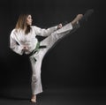 Woman of karate performs a high kick- 01.