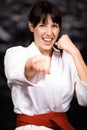 Woman, karate and punch in portrait, fight and self defense sport with muay thai and training. Athlete, combat and power