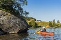 Woman in kayak looking at rock carvings with elks JÃÂ¤mtland Sweden