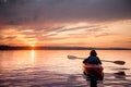 Woman in a kayak on the river on the scenic sunset