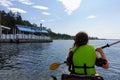 A woman kayaking around Protection Island, visiting a dinghy dock restaurant for a snack, outside Nanaimo, Canada