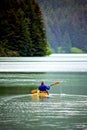 Woman kayaking on calm lake