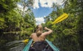 Woman Kayaking down a beautiful tropical jungle river Royalty Free Stock Photo