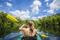 Woman Kayaking down a beautiful tropical jungle river