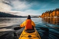 Woman kayaking on a lake in autumn, Ontario, Canada. A persons rear view of enjoying an eco friendly activity of kayaking, AI