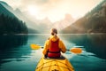 woman kayaking in lake with mountain landscape