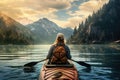 Woman kayaking on lake with mountains in the background at sunset, A female hiker walking in the mountains, no visible faces, Royalty Free Stock Photo