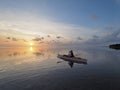 Woman kayaking at sunrise in Bear Cut, Florida.