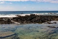 Woman Kayaking and Tide Pool On The Volcanic Shoreline of Keiki Beach Royalty Free Stock Photo