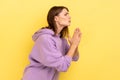 Woman keeping arms in prayer gesture and asking forgiveness, feeling sorry for mistake. Royalty Free Stock Photo