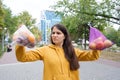 The woman keeps vegetables and fruits in a plastic bag and a cloth shopper.