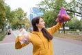 The woman keeps vegetables and fruits in a plastic bag and a cloth shopper.