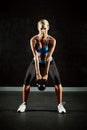 Woman, kettlebell and weightlifting with bodybuilder, exercise and workout in gym, healthy and active person. Portrait