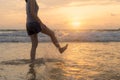 Woman kicking water at the beach during travel holidays vacation outdoors at ocean or nature sea at sunset time, Phuket, Thailand Royalty Free Stock Photo