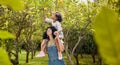 Woman with kid, lemon orchard and piggyback in nature, agriculture with healthy food and nutrition on citrus farm Royalty Free Stock Photo