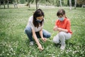 Woman and kid with protection masks on meadow with camomile Royalty Free Stock Photo