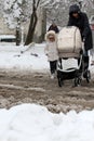 Winter. Ice. Snow. People walks a snowy icy road passing snowy cars on uncleaned icy street after a heavy snowfall. Unclea Royalty Free Stock Photo