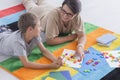 Woman and kid solving puzzle Royalty Free Stock Photo