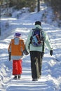 Woman with kid on winter path