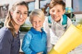 Woman and kids at enrolment day with school cones Royalty Free Stock Photo