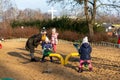 Woman and kids by a seesaw