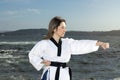 woman in kimono doing martial arts on the beach Royalty Free Stock Photo