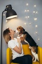 Woman kiss puppy of beagle
