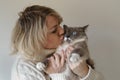 A woman kisses her Siamese cat Royalty Free Stock Photo