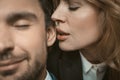 Woman kisses or whispers in man`s ear. Selective focus on female lips near male ear in the center of image. Passionate Royalty Free Stock Photo