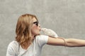 Woman kisses a white rat in her palm