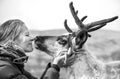 Woman kissing a cute reindeer.