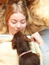 Woman kissing dog waking up in bed after sleeping. Royalty Free Stock Photo