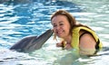 Woman kissing dolphin in pool Royalty Free Stock Photo