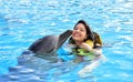 Woman kissing dolphin in pool Royalty Free Stock Photo