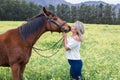 Woman kissing her chestnut Arab horse Royalty Free Stock Photo