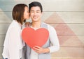 Woman kissing man holding heart Royalty Free Stock Photo