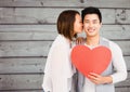 Woman kissing man holding heart Royalty Free Stock Photo