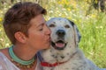 Woman kissing pet rescue dog