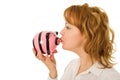 Woman kissing pigg-bank Royalty Free Stock Photo
