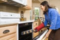 Woman in kitchen.