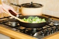 Woman cooking stir fry frozen vegetable on pan Royalty Free Stock Photo
