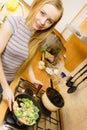 Woman cooking stir fry frozen vegetable on pan Royalty Free Stock Photo