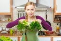 Woman in kitchen having vegetables holding shopping basket Royalty Free Stock Photo