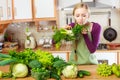 Woman in kitchen having vegetables holding shopping basket Royalty Free Stock Photo