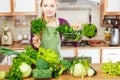 Woman in kitchen having vegetables holding shopping basket Royalty Free Stock Photo