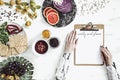 Woman in the kitchen and her healthy food eating selection: fruits, vegetables, super food, seeds, marble background copy space.