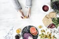 Woman in the kitchen and her healthy food eating selection: fruits, vegetables, super food, seeds, marble background copy space.