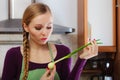 Woman in kitchen holds green fresh chive Royalty Free Stock Photo