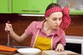 Woman in the kitchen with knife recipe book Royalty Free Stock Photo