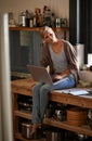 Woman in kitchen, laptop and remote work, think of ideas for food blog, freelancer and copywriting. Working from home Royalty Free Stock Photo